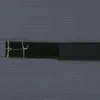 A close-up view of a black fabric strap with white stitching on a textured gray background. Produktbild-Vorschau