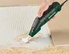 A hand is using an electric scraper tool to remove old adhesive from a surface. Produktbild-Vorschau