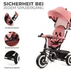 A pink Kinderkraft ASTON tricycle is shown with close-up insets highlighting safety features. Náhled obrázku produktu