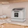 A white countertop with a small dishwasher and some tea set items. Produktbild-Vorschau