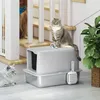 Two cats are near a litter box with a scoop, with stairs and a plant in the background. Produktbild-Vorschau