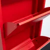 A close-up view of the interior of a red metal shoe cabinet with multiple shelves or compartments. Voir les images du produit