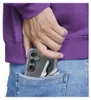 A person's hand is putting a clear phone case with a phone and keys into a denim jeans pocket. Anteprima dell’immagine prodotto