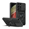 A black phone case with a sliding camera cover and a ring stand is displayed on a white background. Another case is shown from a different angle in the foreground. Produktbild-Vorschau