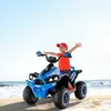 A young boy rides a blue electric quad bike on a beach with the ocean in the background. Produktbild-Vorschau