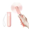 A hand holding a pink portable fan. Anteprima dell’immagine prodotto