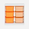A white shelving unit with six storage bins, three orange and three peach, arranged in two columns of three. Produktbild-Vorschau