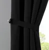 A close-up of a black curtain held back by a tie-back. Produktbild-Vorschau
