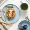 A breakfast setting with pancakes, figs, rosemary, and tea. Náhľad obrázku produktu
