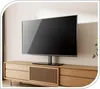 A modern TV stand with a TV on top, placed on a wooden cabinet. Anteprima dell’immagine prodotto