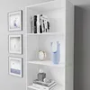 A white bookshelf with books and decorative items on display. Produktbild-Vorschau