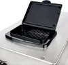 A close-up view of an open black lid on a stainless steel appliance. Produktbild-Vorschau