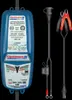 A blue battery charger and its accessories are displayed against a black background. Voir les images du produit