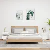 A bedroom scene with a bed, nightstands, and artwork on the wall. Produktbild-Vorschau