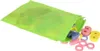 A bright green mesh bag with colorful wooden numbers spilling out onto a white background. Produktbild-Vorschau