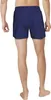 A person's lower body wearing blue NIKE SWIM shorts. Podgląd zdjęcia produktu