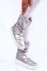 A person wearing silver snow boots. Produktbild-Vorschau