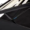 A close-up view of the internal mechanism of a bed frame, showing wooden slats and a gas strut. Produktbild-Vorschau