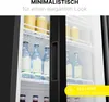 Interior of a black glass-door refrigerator filled with bottles and jugs. Produktbild-Vorschau