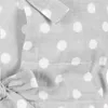 A close-up view of a grey fabric with white polka dots, featuring a tied bow detail and stitching. Anteprima dell’immagine prodotto