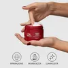 Hands holding a red jar of hair mask, with icons and text below. Anteprima dell’immagine prodotto