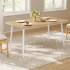 A dining table set with plates and a flower arrangement in a well-lit room. Produktbild-Vorschau