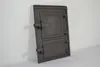A dark gray cast iron door with two openings, designed for ovens, is shown against a white and light gray background. Anteprima dell’immagine prodotto