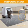 A cat is stepping out of a litter box onto a gray mat designed to catch litter. The mat has a textured surface with raised lines and small indentations. Close-up insets show the texture of the mat and some cat litter caught in it. Produktbild-Vorschau