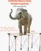 An elephant stands on a folding table to demonstrate its weight capacity. Voir les images du produit