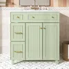 A light green bathroom vanity with a marble countertop and gold hardware is shown in a bathroom setting. The vanity has two drawers on top, one cabinet door on the left, and two cabinet doors on the right. It sits on a floor with a decorative tile pattern. Anteprima dell’immagine prodotto