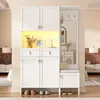 A white entryway storage unit with a bench and mirror, set against a neutral wall. Produktbild-Vorschau