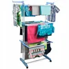 A multi-tiered drying rack with various clothes hanging on it. Produktbild-Vorschau