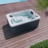 A hot tub is placed on a wooden deck next to a swimming pool. Voir les images du produit