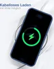 A smartphone with a blue case is placed on a wireless charger, indicating it is charging. Produktbild-Vorschau