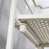Close-up of a metal shelf bracket and a perforated shelf. Voir les images du produit