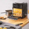 An air fryer oven on a kitchen counter, filled with food, with accessories and ingredients nearby. Produktbild-Vorschau