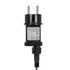 A close-up shot of a black power adapter with a European plug. Voir les images du produit