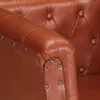 A close-up view of the armrest and side of a brown leather armchair. Produktbild-Vorschau