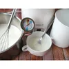 A yogurt maker with a thermometer and whisk, suggesting the process of making yogurt. Anteprima dell’immagine prodotto