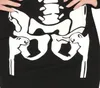 A close-up view of a black dress with a white skeleton print on the hip and pelvic area. Produktbild-Vorschau