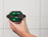 A hand holding a green and black laser level against a tiled wall, with a red laser line projecting horizontally. Produktbild-Vorschau