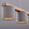 A close-up view of a pendant light fixture with multiple grey fabric shades hanging from a wooden beam. Produktbild-Vorschau