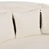 Close-up view of beige cushions on a woven outdoor furniture set. Voir les images du produit