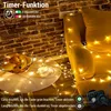 A cozy living room scene with string lights draped over furniture and a table with fruit. Voir les images du produit