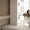 A close-up view of a vanity table with lights. Produktbild-Vorschau