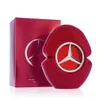 A red perfume bottle and its packaging are displayed against a white background. Voir les images du produit