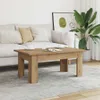 A coffee table in a living room setting with a sofa and plant. Produktbild-Vorschau