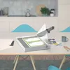 A paper cutter is shown on a table in a modern kitchen setting. Náhľad obrázku produktu