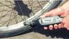 A hand is using a Dremel 3000 rotary tool to clean a bicycle wheel rim. Produktbild-Vorschau
