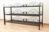 A black metal shoe rack with three shelves, decorated with ornate scrollwork and leaf motifs. Produktbild-Vorschau